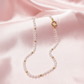 Collar de perlas con fondo rosa